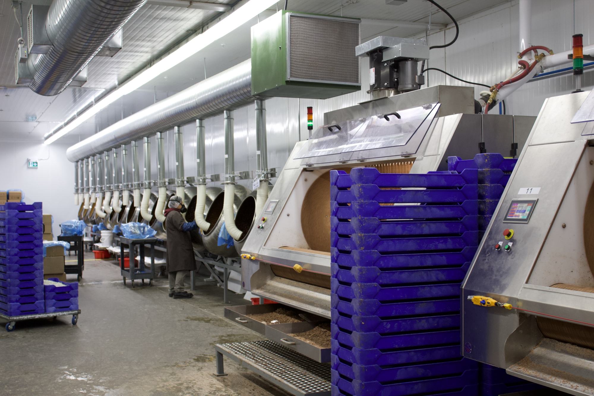 Food packaging hall with stainless equipment and blue totes
