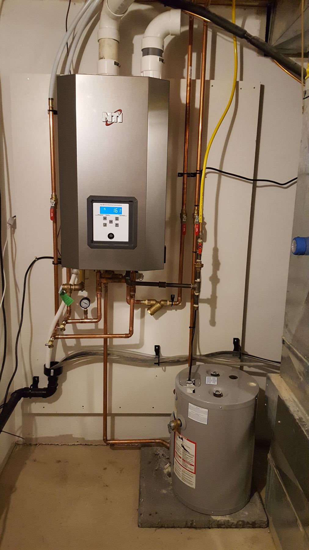 Wall-mounted tankless water heater with copper and gas piping